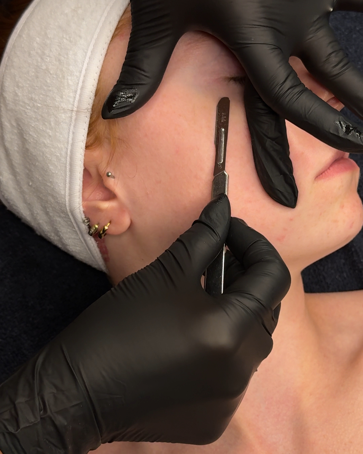 Client receiving the dermaplane portion of the Glass Skin Facial